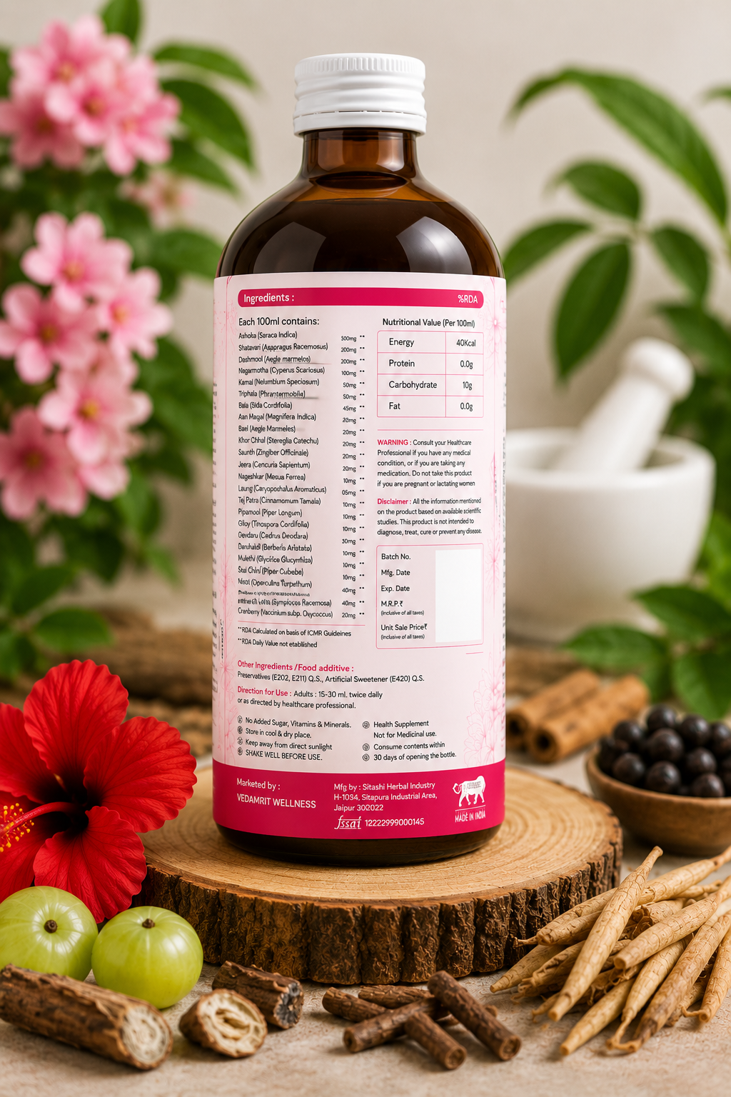 Bottle with a label on a wooden surface with flowers and herbs in the background